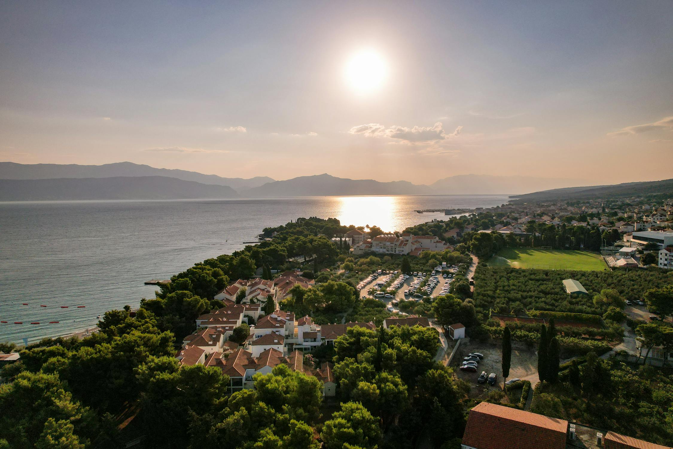 free-photo-of-the-sun-is-shining-over-the-ocean-and-the-city